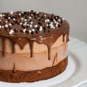 chocolate cake with white icing on white ceramic plate