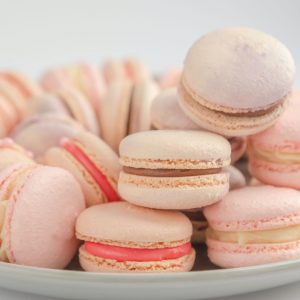 pink and white macaroons on white ceramic bowl